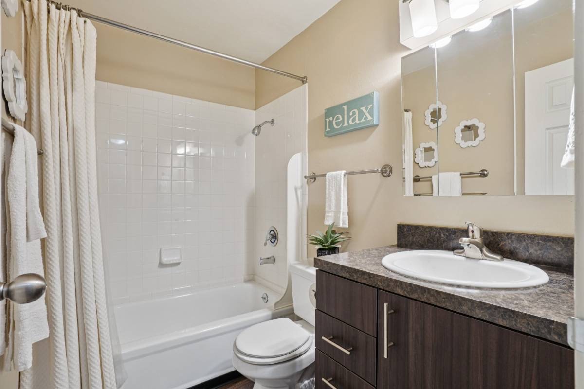 Renovated bathroom with dark vanity, from Unit 181's listing
