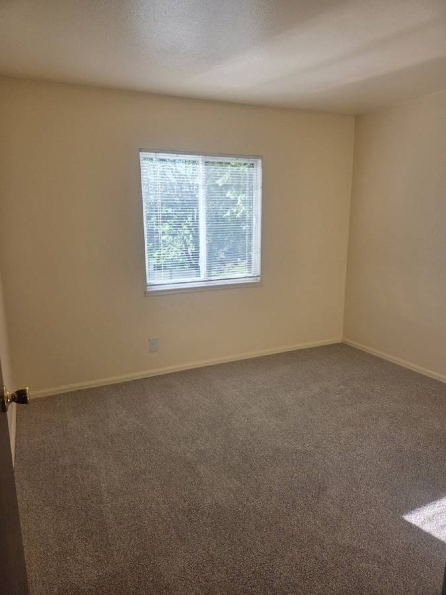 Bedroom with large window, representative of Unit 64