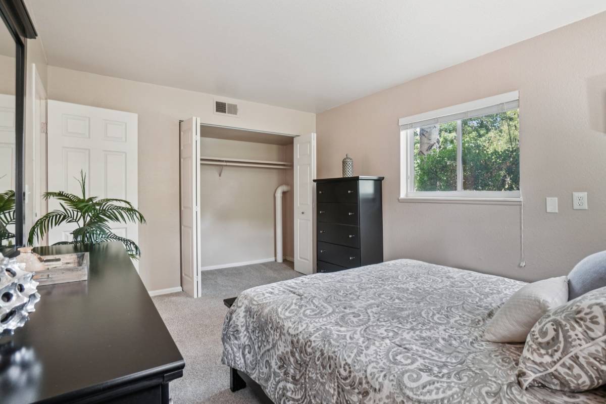 Furnished bedroom with walk-in closet, from Unit 135's renovated listing