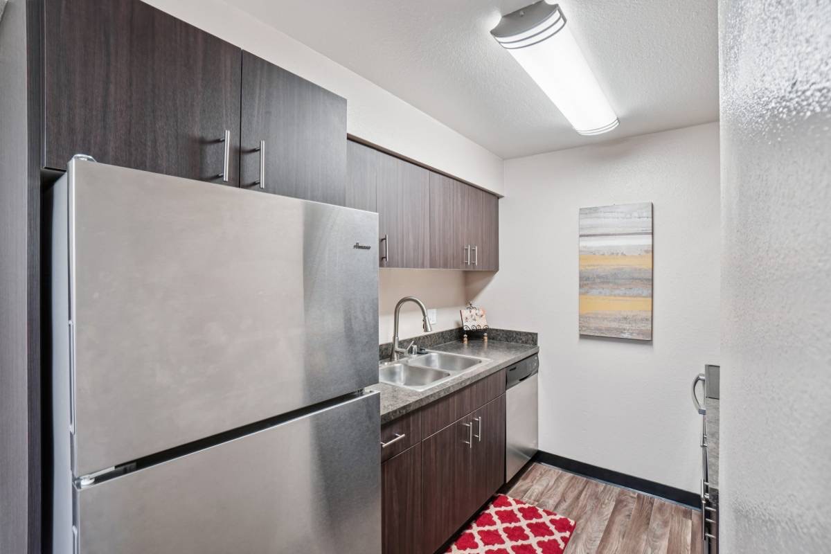 Renovated kitchen with stainless appliances, from Unit 214's listing