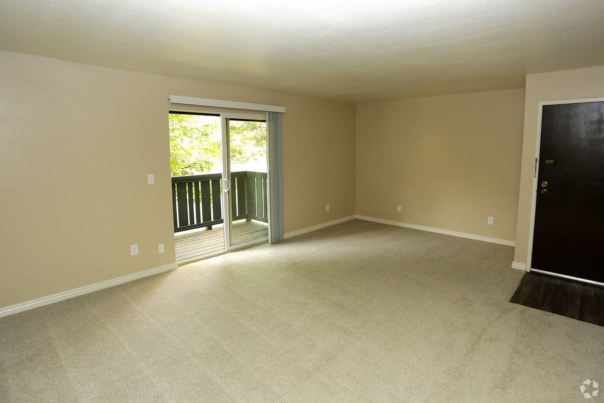 Living room with sliding door to a private balcony, representative of Unit 179